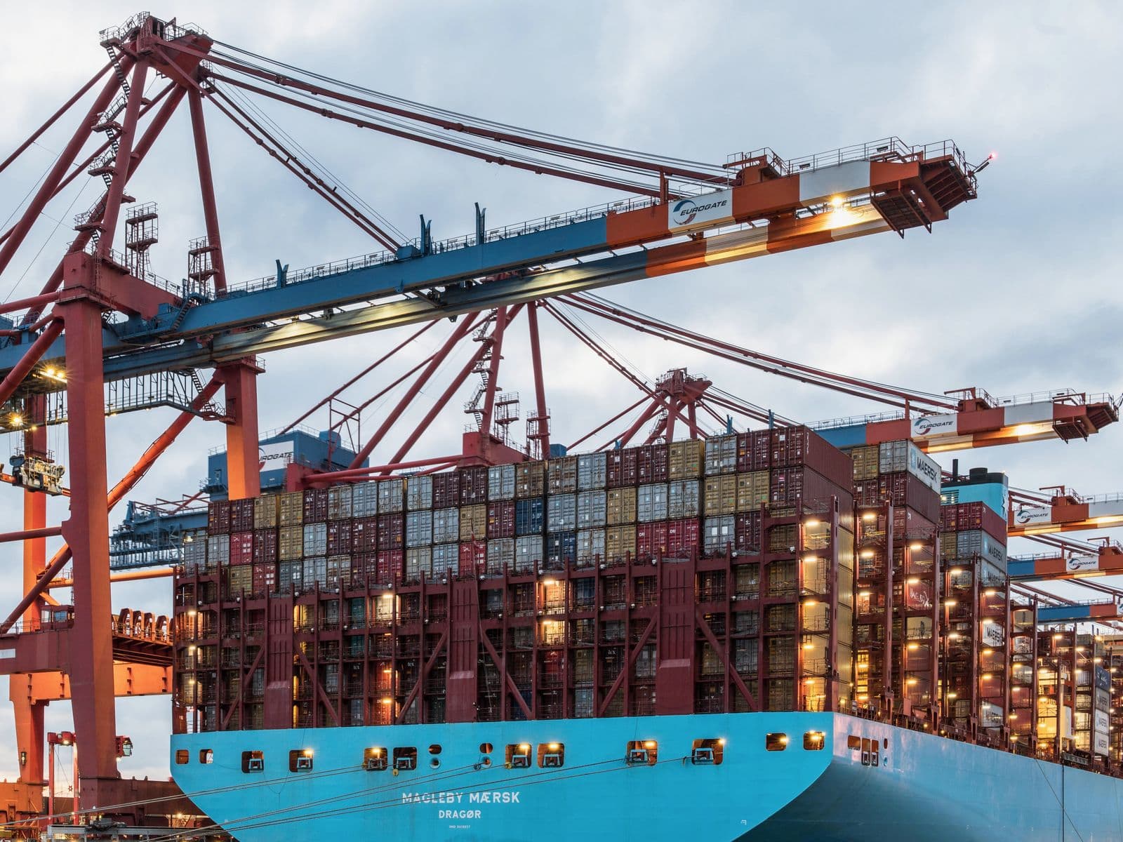 Container ship being loaded by ship-to-shore cranes at a port terminal